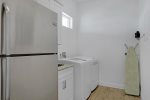 Laundry room with an additional fridge for extra storage